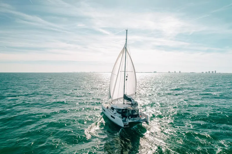 Cloud II Yacht Photos Pics Sailing Lagoon 40 catamaran on open sea, 2023 model, under clear sky.
