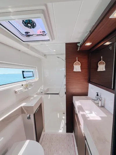 Cloud II Yacht Photos Pics Modern bathroom interior of 2023 Lagoon 40 yacht with sleek design and ocean view.