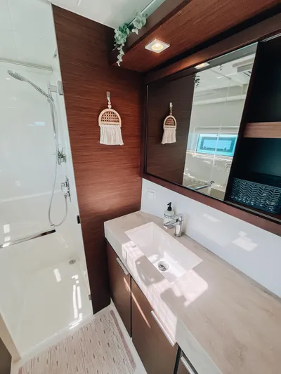 Cloud II Yacht Photos Pics Modern bathroom interior in 2023 Lagoon 40 yacht, featuring sleek design and elegant fixtures.