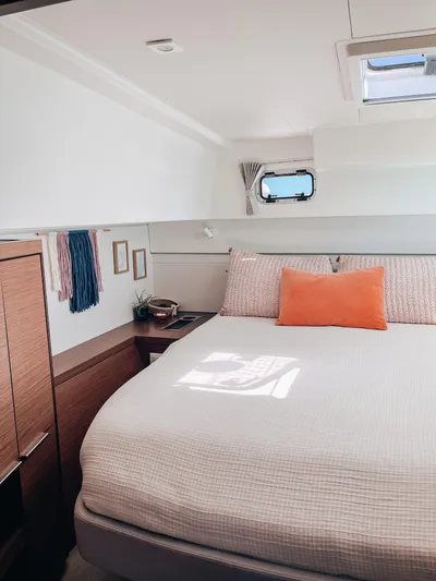 Cloud II Yacht Photos Pics 2023 Lagoon 40 yacht cabin interior with cozy bed and modern decor.