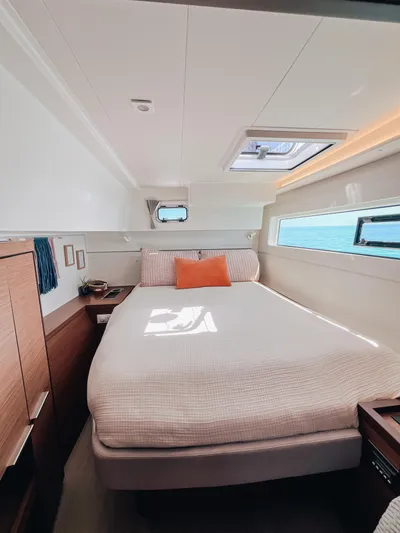Cloud II Yacht Photos Pics Luxurious cabin interior of 2023 Lagoon 40 catamaran with cozy bed and modern decor.
