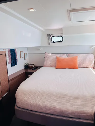 Cloud II Yacht Photos Pics 2023 Lagoon 40 yacht cabin with cozy bed, modern decor, and natural light.