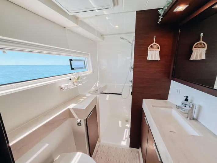 Cloud II Yacht Photos Pics Luxurious bathroom interior of 2023 Lagoon 40 yacht with ocean view.