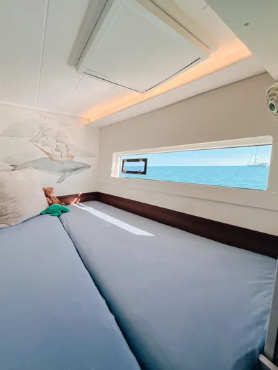 Cloud II Yacht Photos Pics Cozy cabin interior of 2023 Lagoon 40 catamaran with ocean view and nautical decor.