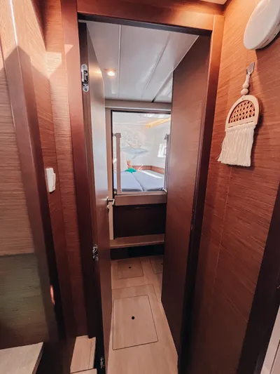 Cloud II Yacht Photos Pics Interior view of 2023 Lagoon 40 yacht cabin with wooden finish and cozy decor.