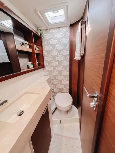 Cloud II Yacht Photos Pics Modern bathroom in 2023 Lagoon 40 yacht with elegant wood finish and stylish wallpaper.