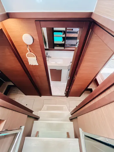 Cloud II Yacht Photos Pics 2023 Lagoon 40 interior with wooden stairs leading to a modern bathroom.