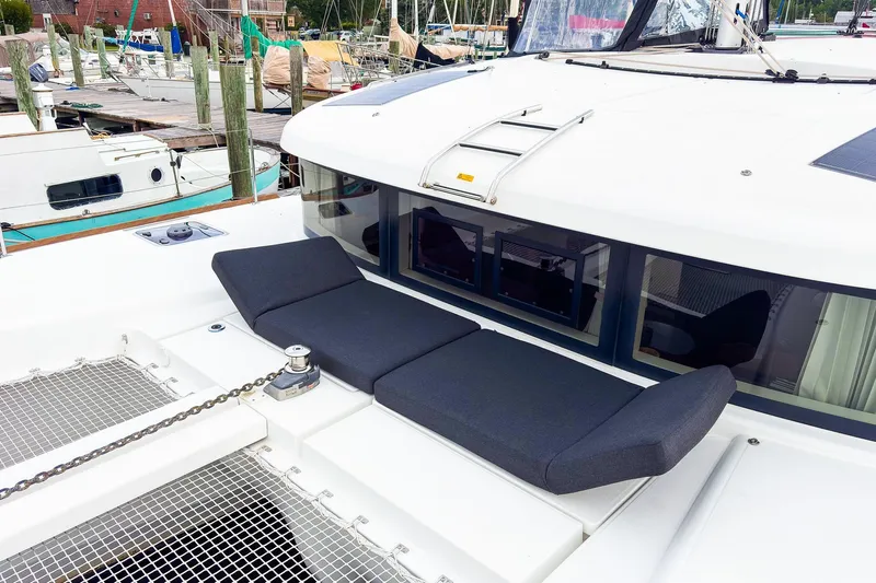 Cloud II Yacht Photos Pics 2023 Lagoon 40 catamaran with cushioned deck seating at marina.