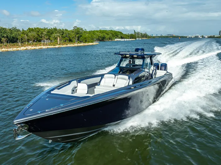  Yacht Photos Pics 2024 Nor-Tech 450 Sport Center Console cruising on a scenic waterway.
