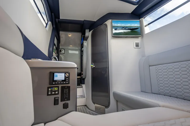  Yacht Photos Pics 2024 Nor-Tech 450 Sport Center Console interior with modern seating and control panel.