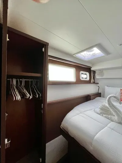 Smooth Sailor Yacht Photos Pics Luxurious cabin interior of 2019 Lagoon 450 yacht with bed and closet.