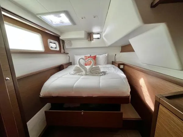 Smooth Sailor Yacht Photos Pics Luxurious cabin interior of 2019 Lagoon 450 yacht with elegant bedding and swan towel decor.