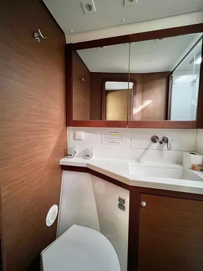 Smooth Sailor Yacht Photos Pics Modern bathroom interior on 2019 Lagoon 450 yacht, featuring wood accents and sleek fixtures.