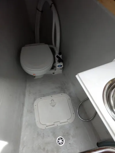 Smooth Sailor Yacht Photos Pics Lagoon 450 yacht bathroom interior, featuring a compact toilet and sink, 2019 model.