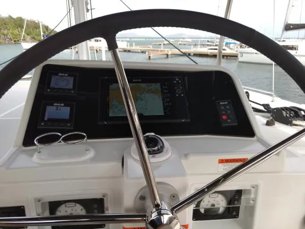 Smooth Sailor Yacht Photos Pics Helm of 2019 Lagoon 450 catamaran with navigation instruments and steering wheel.