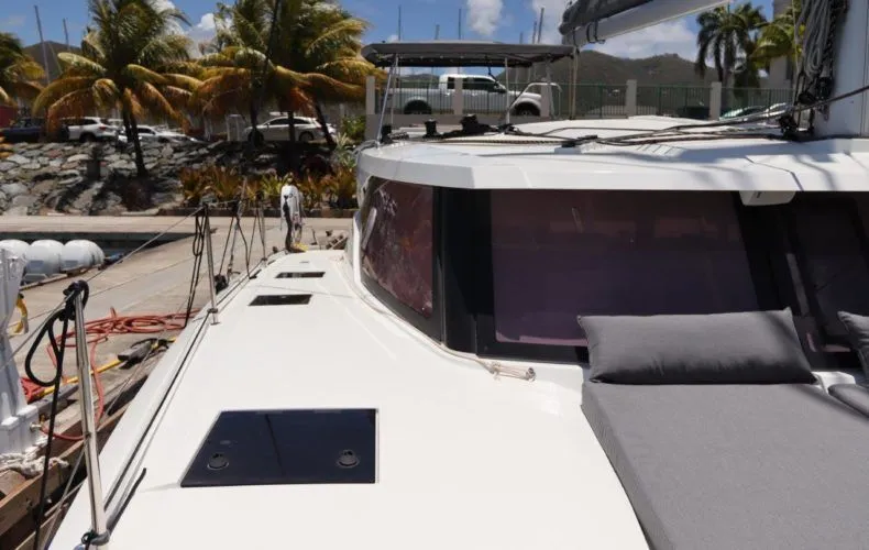 Wish You Were Here Yacht Photos Pics Fountaine Pajot Lucia 40 catamaran, 2020 model, docked under sunny skies with palm trees.