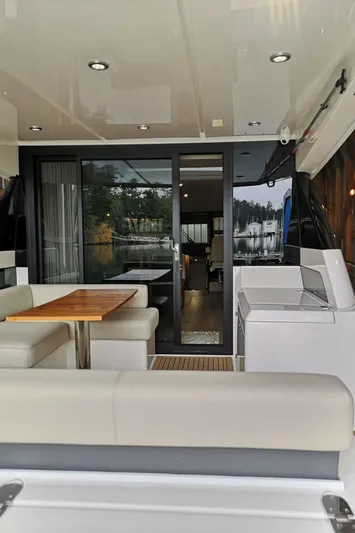 City Lights Yacht Photos Pics 2021 Maritimo X50 yacht interior with modern seating and dining area.
