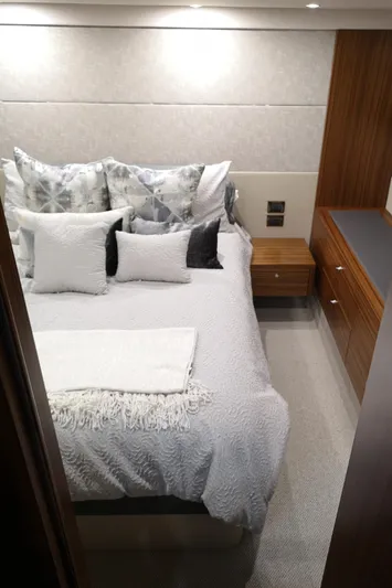 City Lights Yacht Photos Pics Luxurious bedroom interior of 2021 Maritimo X50 yacht with elegant bedding and wood accents.