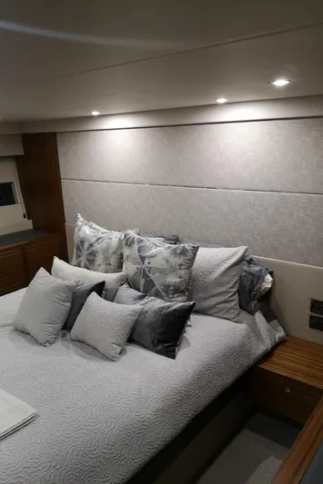 City Lights Yacht Photos Pics Luxurious bedroom interior of 2021 Maritimo X50 yacht with elegant bedding and ambient lighting.
