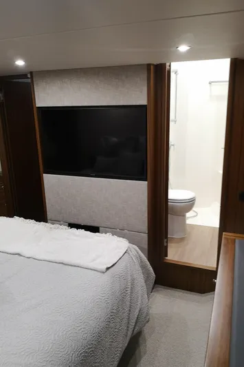City Lights Yacht Photos Pics Luxurious 2021 Maritimo X50 yacht bedroom with ensuite bathroom and modern decor.