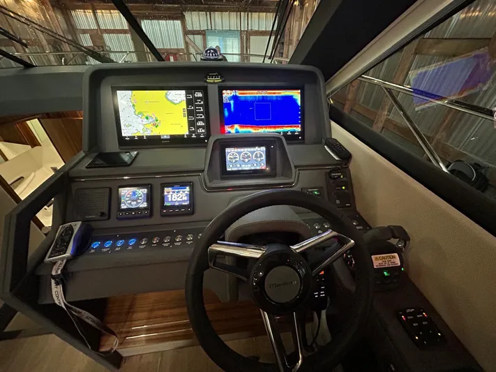 City Lights Yacht Photos Pics 2021 Maritimo X50 helm with advanced navigation displays and controls in a sleek, modern design.