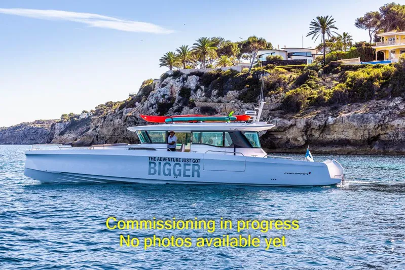  Yacht Photos Pics 2024 Axopar 45 XC Cross Cabin BRABUS Trim boat on scenic coastal waters.