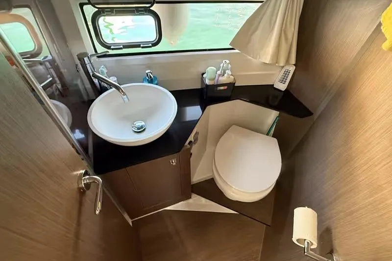  Yacht Photos Pics 2024 Jeanneau Merry Fisher 1095 Fly bathroom with modern sink and toilet.
