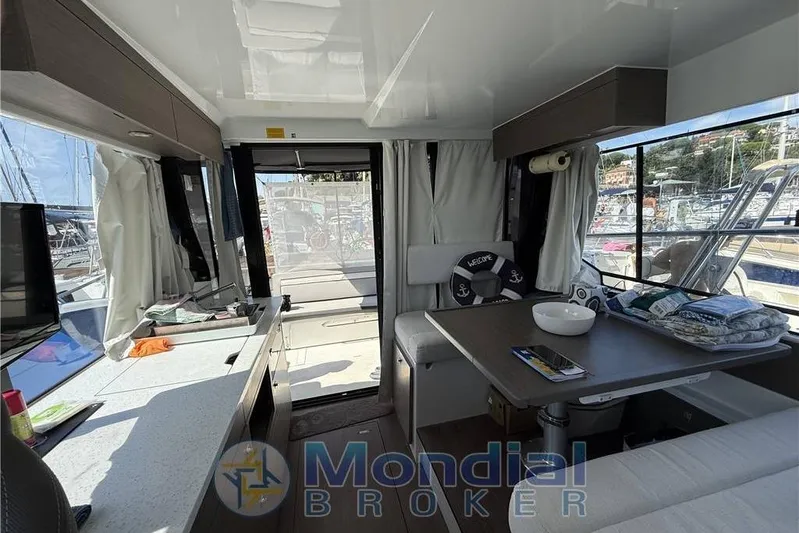  Yacht Photos Pics Interior of 2024 Jeanneau Mary Fischer 10,95 yacht with modern dining area and marina view.