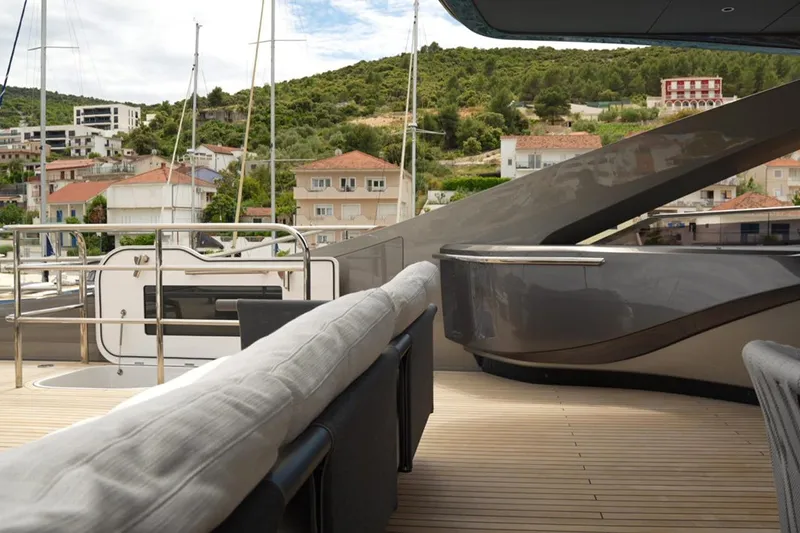  Yacht Photos Pics Luxurious deck of 2025 Princess Y95 yacht with scenic coastal backdrop.