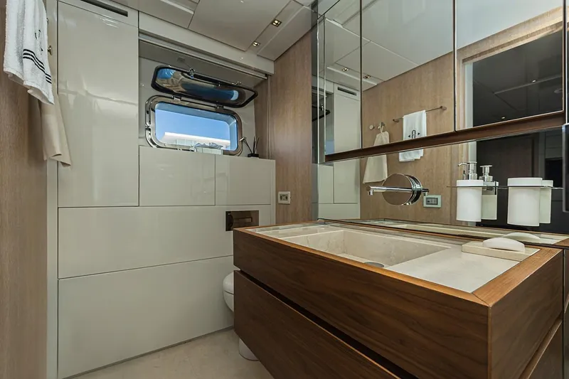 Percal Yacht Photos Pics Luxurious bathroom in 2014 Sanlorenzo SL104-586 yacht with modern fixtures and wooden cabinetry.