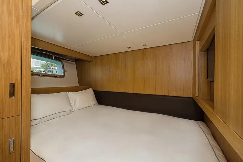 Percal Yacht Photos Pics Luxurious cabin interior of 2014 Sanlorenzo SL104-586 yacht with wood paneling and cozy bed.