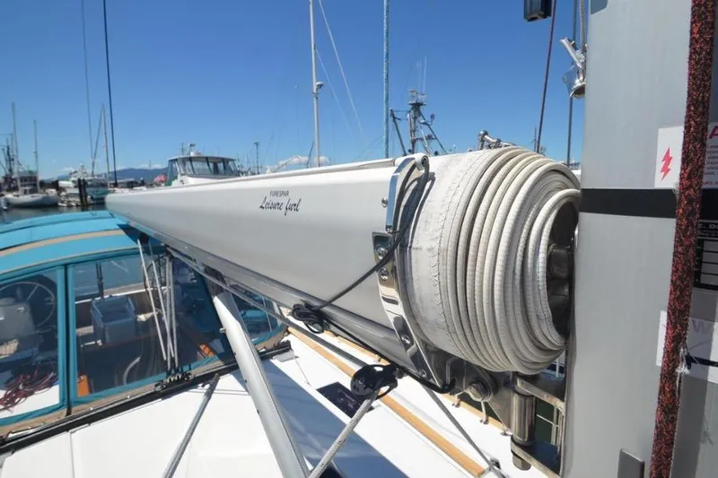 Leah Yacht Photos Pics 2014 Jeanneau Sun Odyssey 469 sailboat with rolled sail at marina.