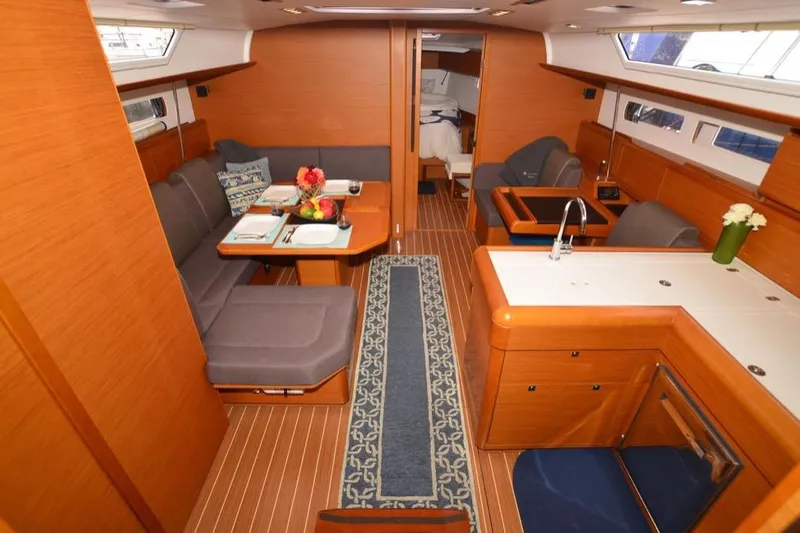 Leah Yacht Photos Pics Luxurious interior of 2014 Jeanneau Sun Odyssey 469 yacht with elegant wood finish.
