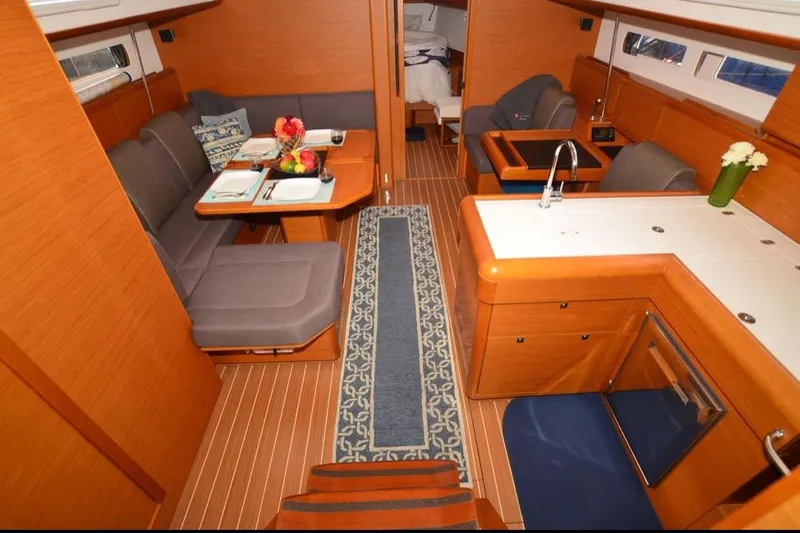 Leah Yacht Photos Pics Interior of 2014 Jeanneau Sun Odyssey 469 yacht with elegant wood finish and modern amenities.