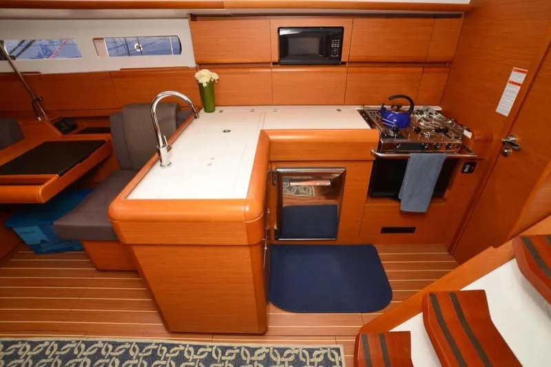 Leah Yacht Photos Pics 2014 Jeanneau Sun Odyssey 469 yacht interior with modern kitchen and dining area.