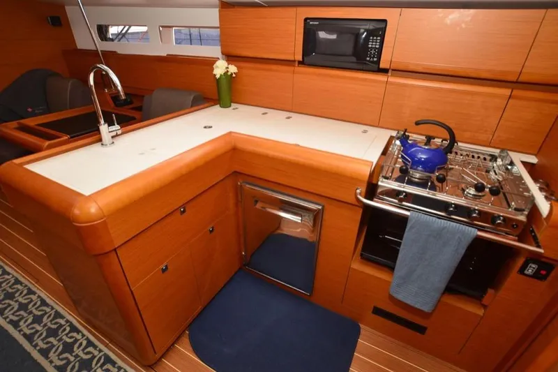 Leah Yacht Photos Pics 2014 Jeanneau Sun Odyssey 469 yacht kitchen with modern appliances and wooden cabinetry.