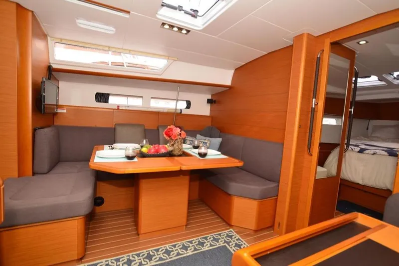 Leah Yacht Photos Pics Interior of 2014 Jeanneau Sun Odyssey 469 yacht with cozy dining area and modern furnishings.