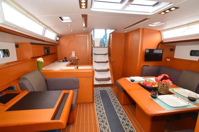 Leah Yacht Photos Pics Interior of 2014 Jeanneau Sun Odyssey 469 yacht, featuring elegant dining and kitchen area.