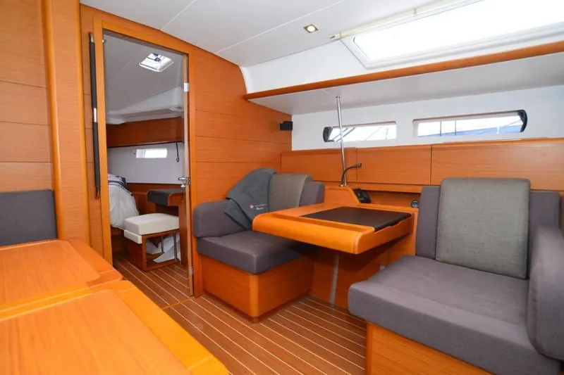 Leah Yacht Photos Pics Interior of 2014 Jeanneau Sun Odyssey 469 yacht, featuring cozy seating and wooden finishes.