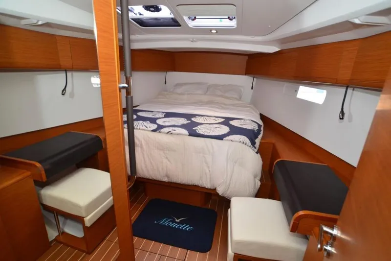 Leah Yacht Photos Pics 2014 Jeanneau Sun Odyssey 469 cabin interior with cozy bed and wooden furnishings.