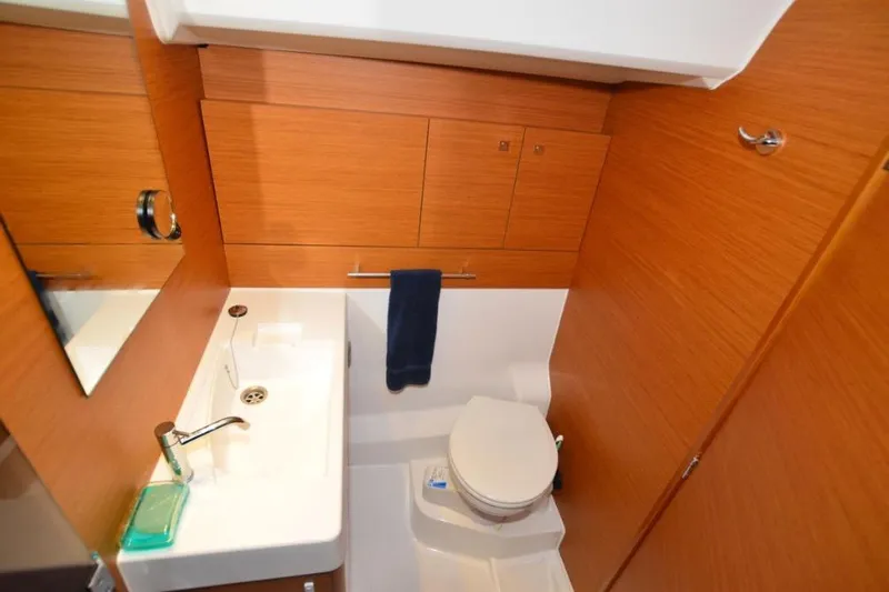 Leah Yacht Photos Pics 2014 Jeanneau Sun Odyssey 469 bathroom with wooden cabinetry and modern fixtures.