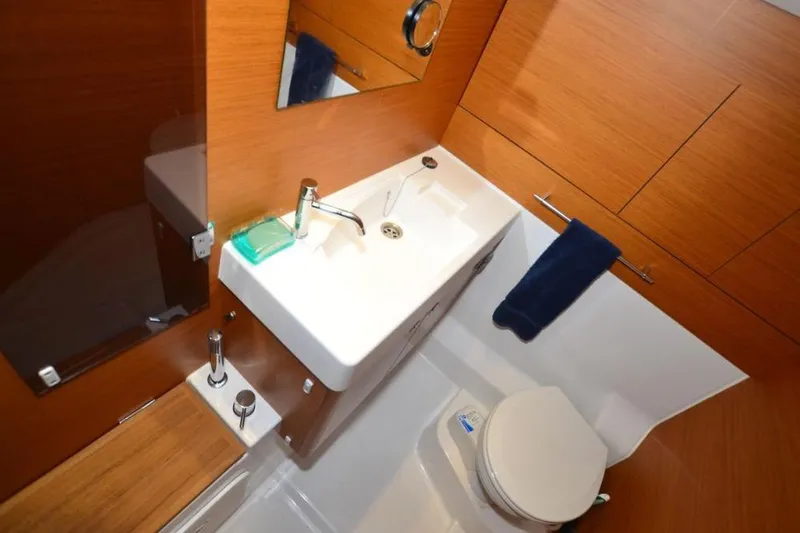 Leah Yacht Photos Pics Bathroom interior of 2014 Jeanneau Sun Odyssey 469 yacht, featuring sink and toilet.