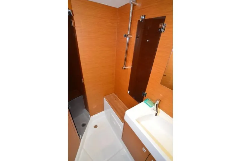 Leah Yacht Photos Pics 2014 Jeanneau Sun Odyssey 469 bathroom with modern fixtures and wood paneling.