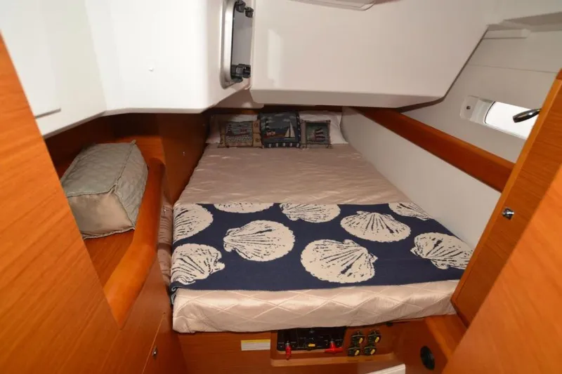 Leah Yacht Photos Pics Cozy cabin interior of 2014 Jeanneau Sun Odyssey 469 sailboat with nautical-themed bedding.