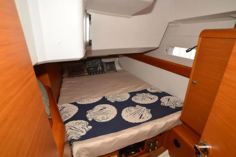 Leah Yacht Photos Pics Cozy cabin interior of 2014 Jeanneau Sun Odyssey 469 sailboat with nautical-themed bedding.