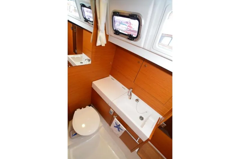 Leah Yacht Photos Pics 2014 Jeanneau Sun Odyssey 469 bathroom with modern fixtures and wooden cabinetry.