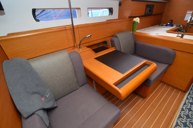 Leah Yacht Photos Pics Interior of 2014 Jeanneau Sun Odyssey 469 yacht with cozy seating and wooden finishes.