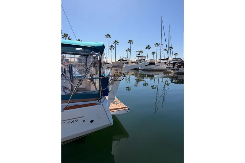 Leah Yacht Photos Pics 2014 Jeanneau Sun Odyssey 469 yacht docked in a marina with palm trees.