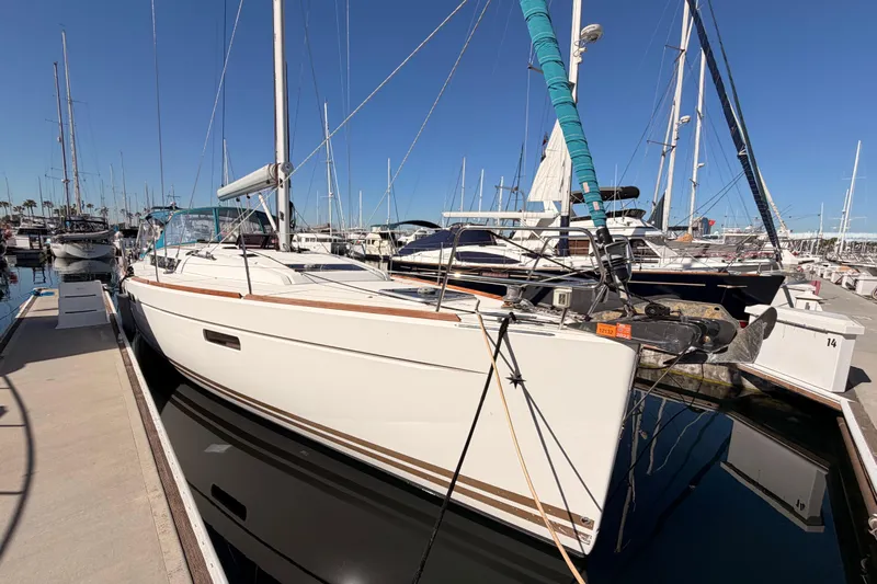 Leah Yacht Photos Pics 2014 Jeanneau Sun Odyssey 469 sailboat docked in a marina under clear blue skies.