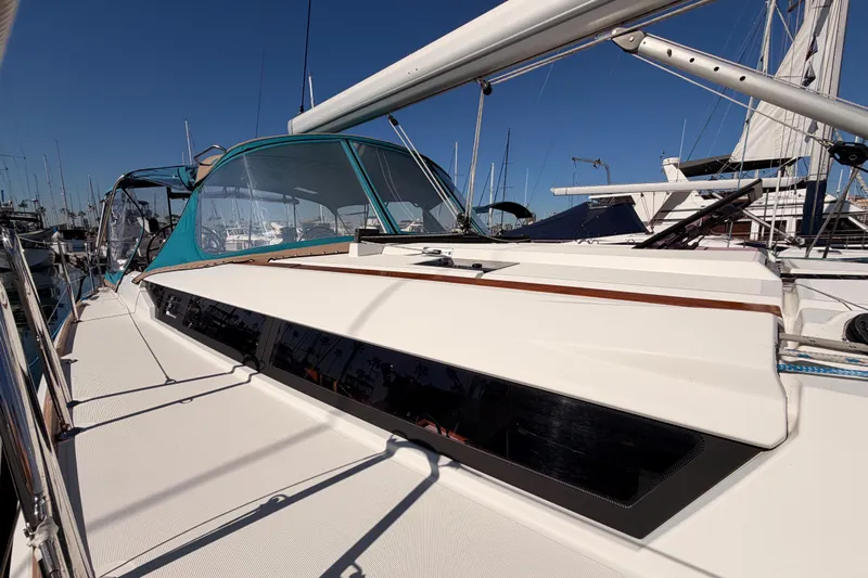 Leah Yacht Photos Pics 2014 Jeanneau Sun Odyssey 469 sailboat docked, featuring sleek design and blue canopy.